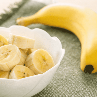 bananas on a table and in a white bowl