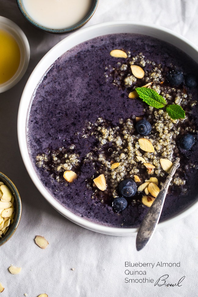 The blueberry almond breakfast quinoa smoothie bowl topped with quinoa, blueberries, and seeds.
