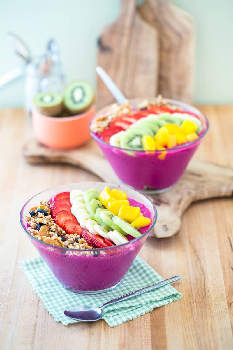 The purple dragon fruit smoothie bowl topped with granola, blueberries, strawberries, bananas, kiwi, and pineapple.