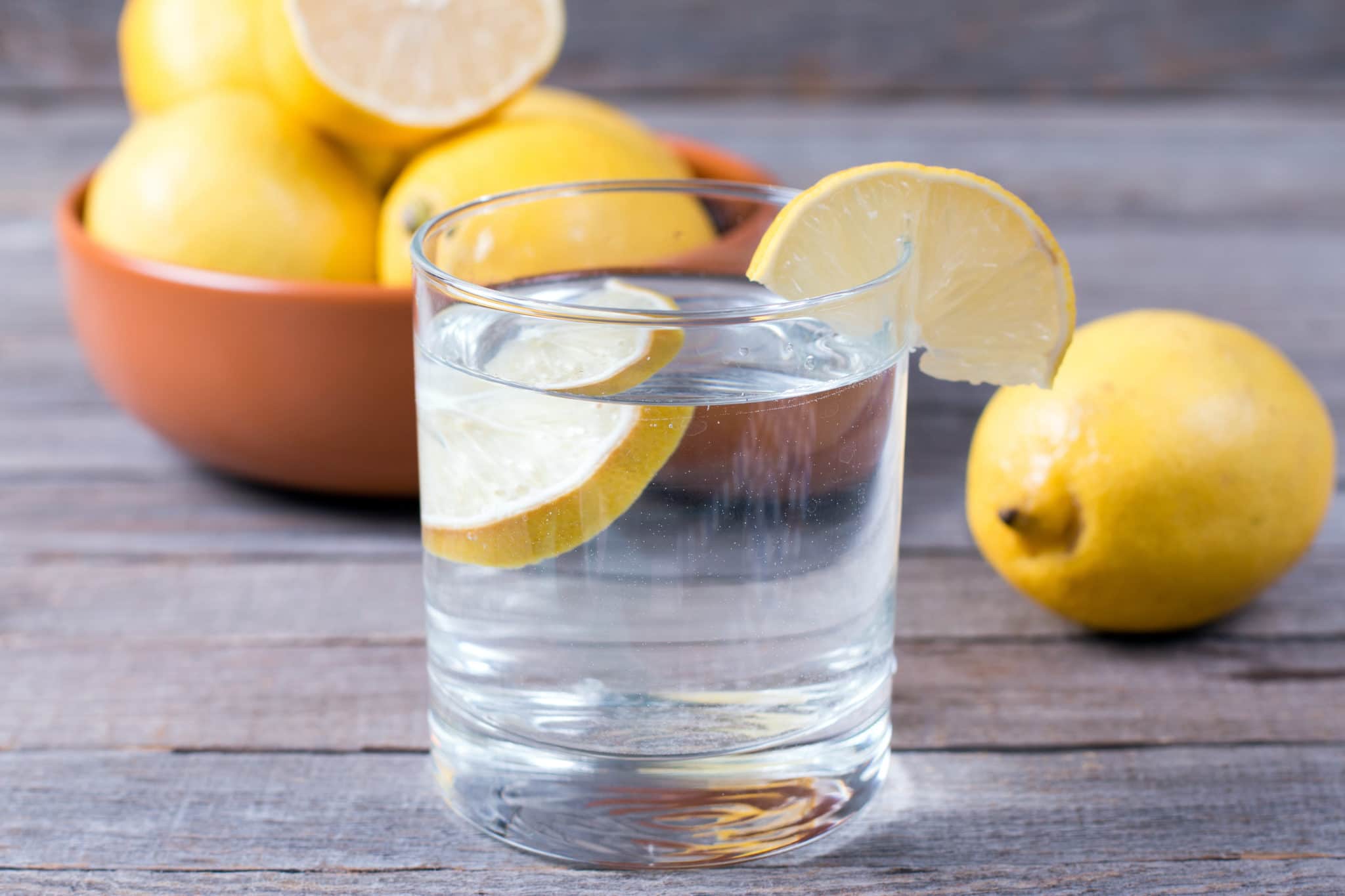 Glass of lemon water on table