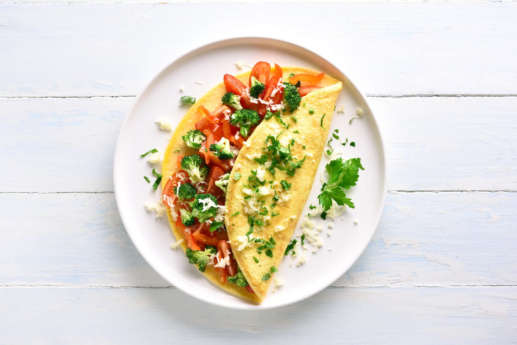Protein-packed veggie omelet on white table and plate