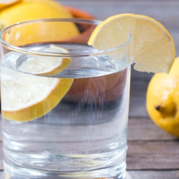 Glass of lemon water on table