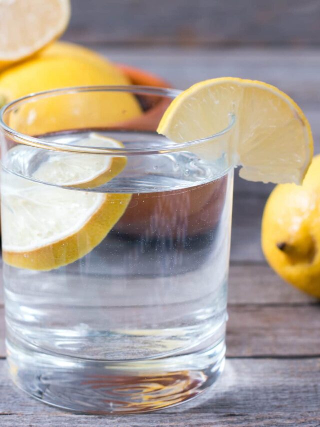 Glass of lemon water on table