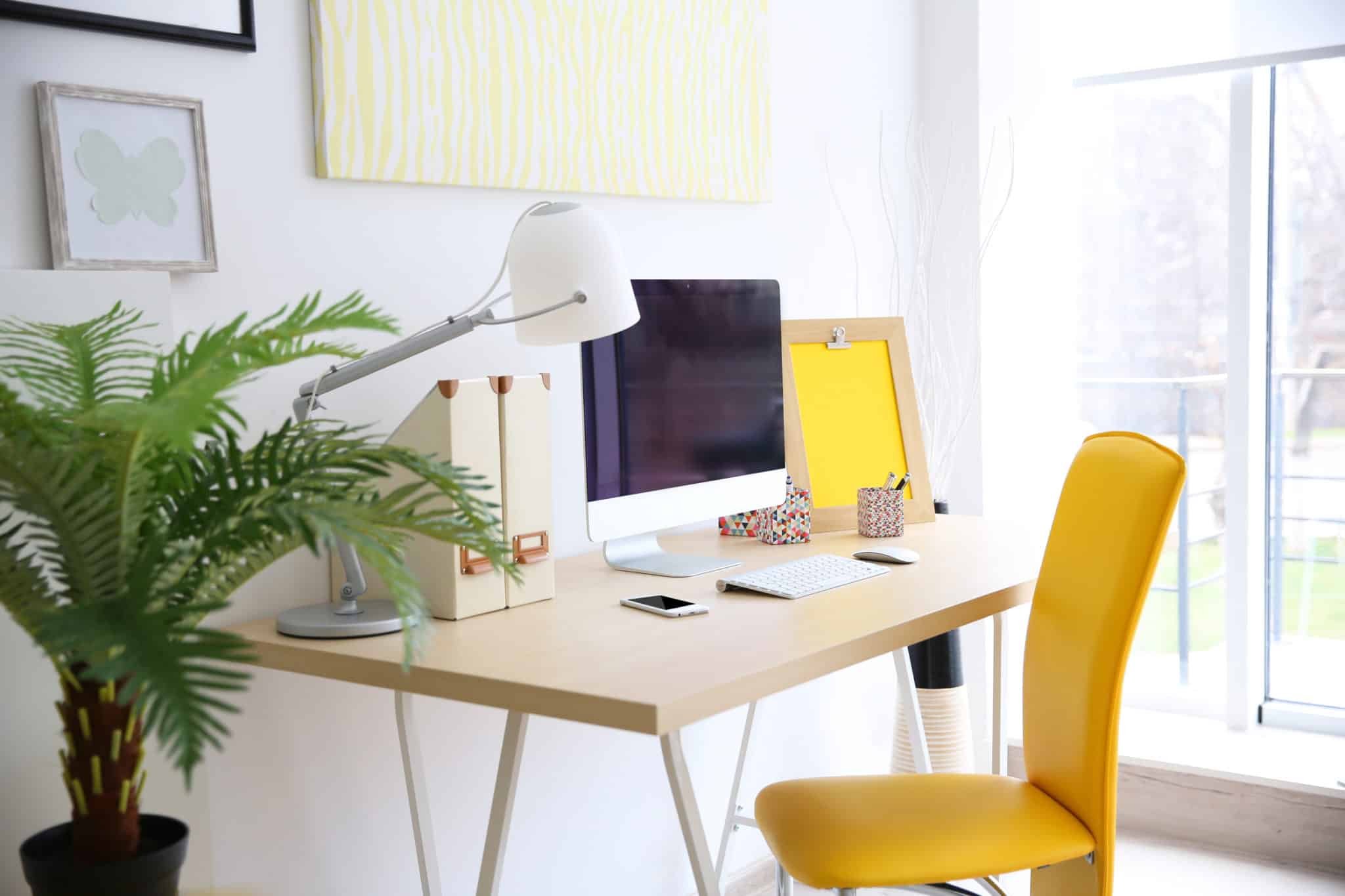 Pretty white home office with yellow chair