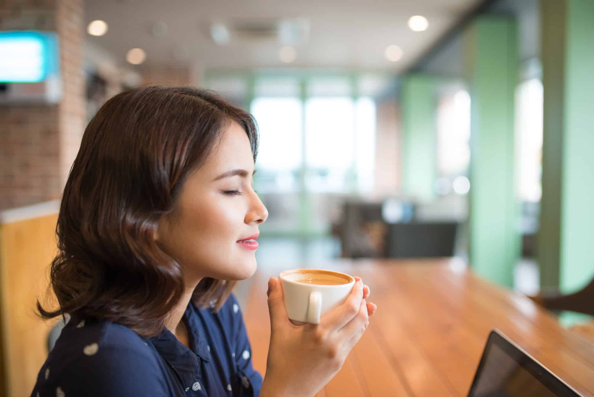 Woman savoring her cup of coffee