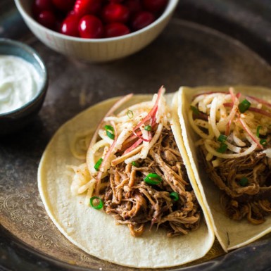 These gluten-free slow cooker chipotle pulled pork tacos with cranberries and apples are the perfect healthy winter meal packed with protein and sassy flavor!