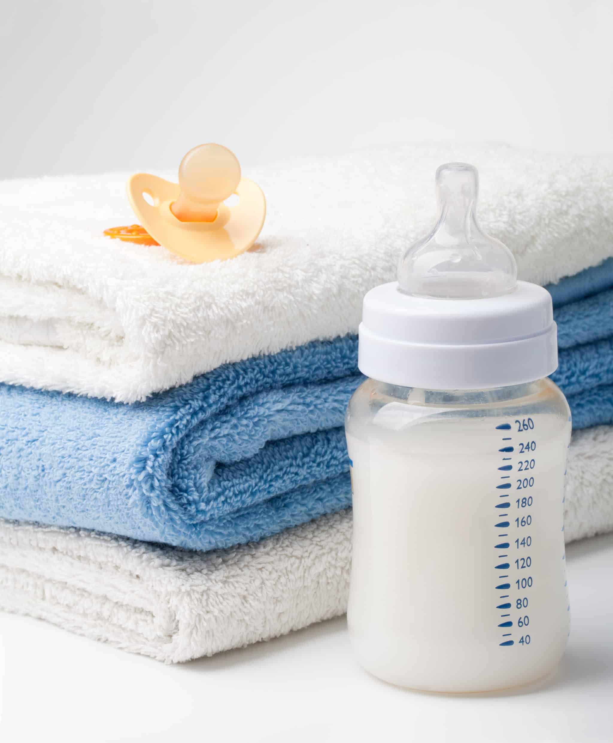 stack of towel with a baby bottle