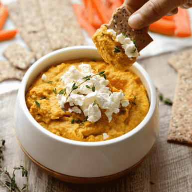 The PERFECT fall snack: sweet potato hummus topped with fresh thyme and goat cheese. Pair with your favorite veggies!