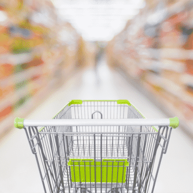 Grocery cart in grocery store aisle looking for healthy packaged foods