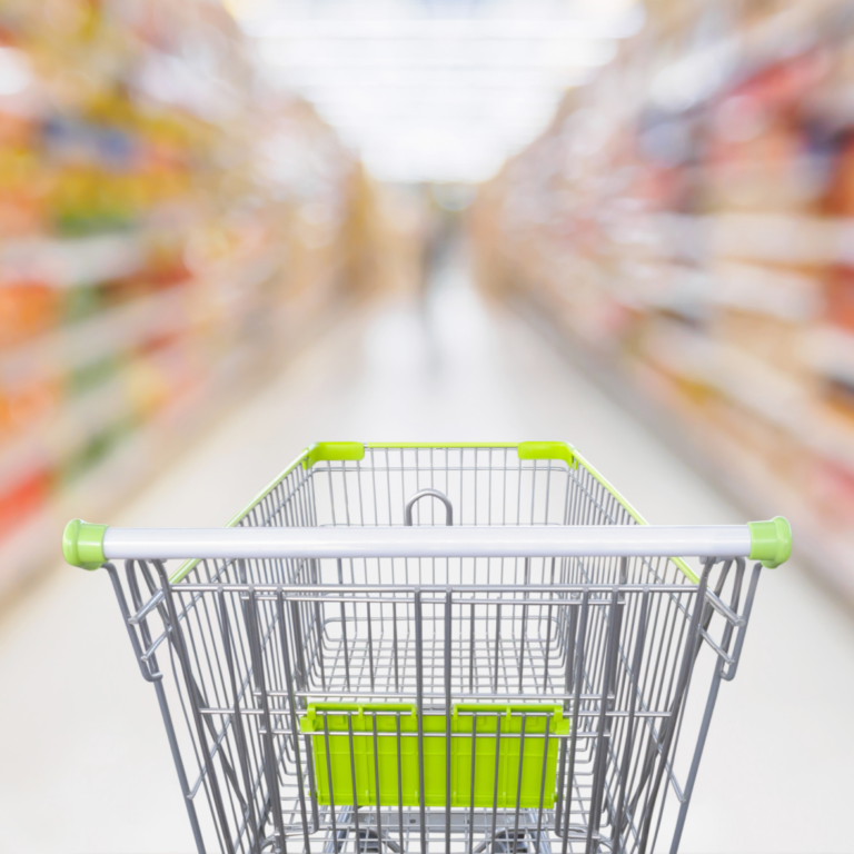 Grocery cart in grocery store aisle looking for healthy packaged foods