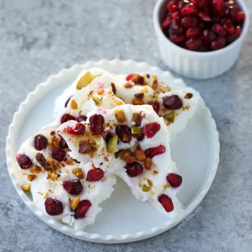This festive frozen yogurt bark is a perfect sweet and salty combo with pomegranate and pistachios. Make it for a snack or dessert!
