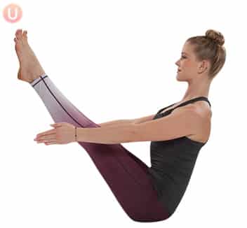 Practice boat pose to get a lean and defined lower body.