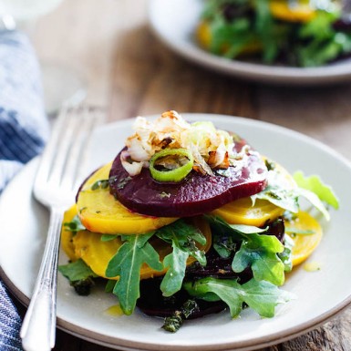 Whip up this gourmet roasted stacked beet salad with crispy shallots and herb infused oil for a flavor sensation filled with nutrition and vitamins!