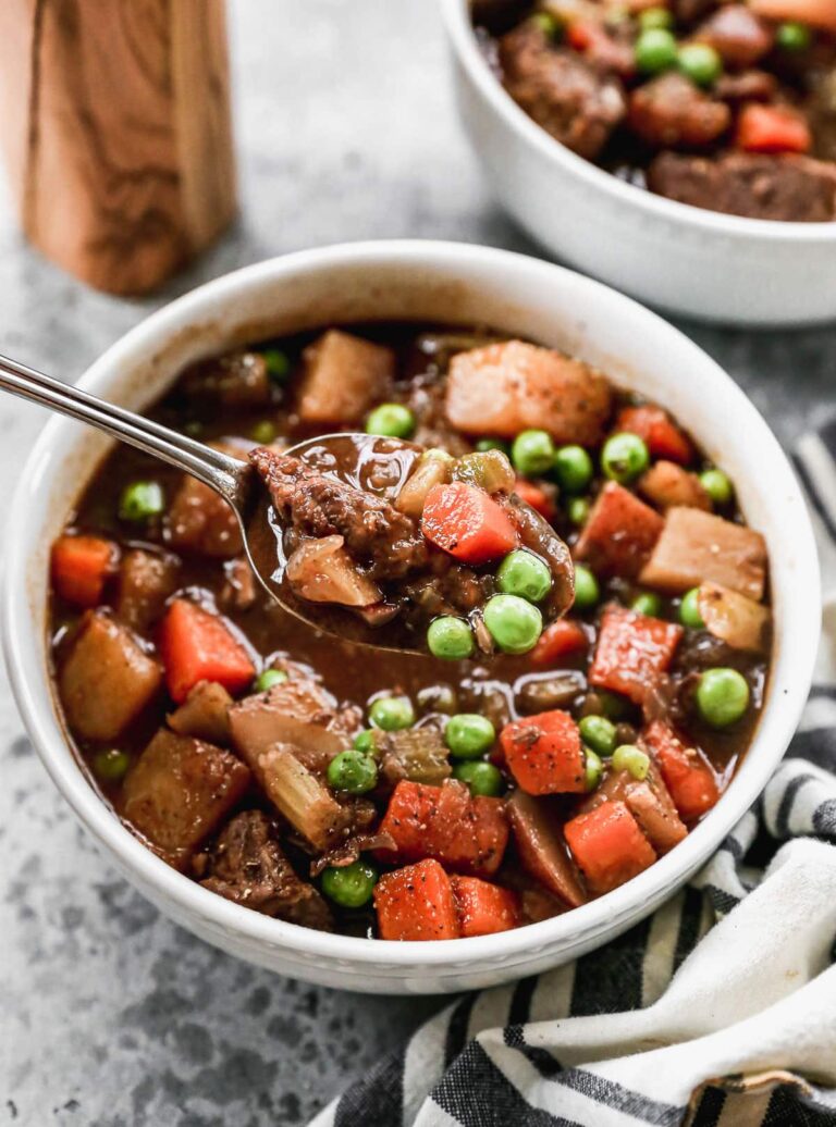 A white bowl of healthy beef stew with vegetables