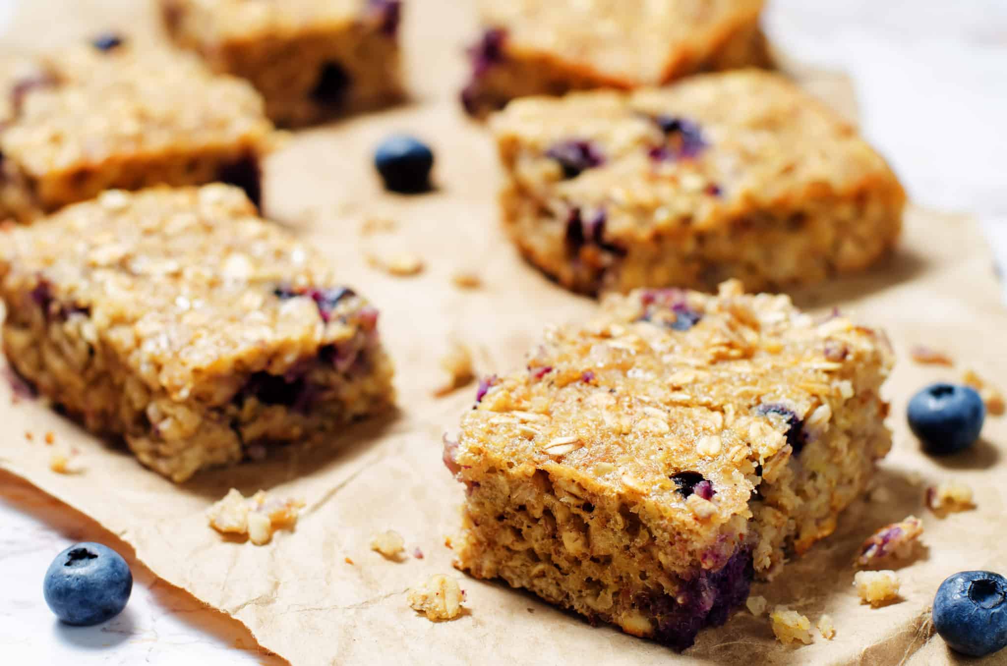 Blueberry Quinoa Oats Breakfast Bars on brown paper.