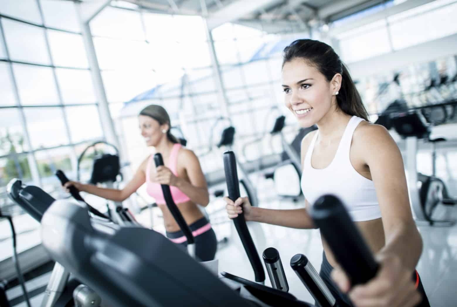 Women at the gym exercising on machines