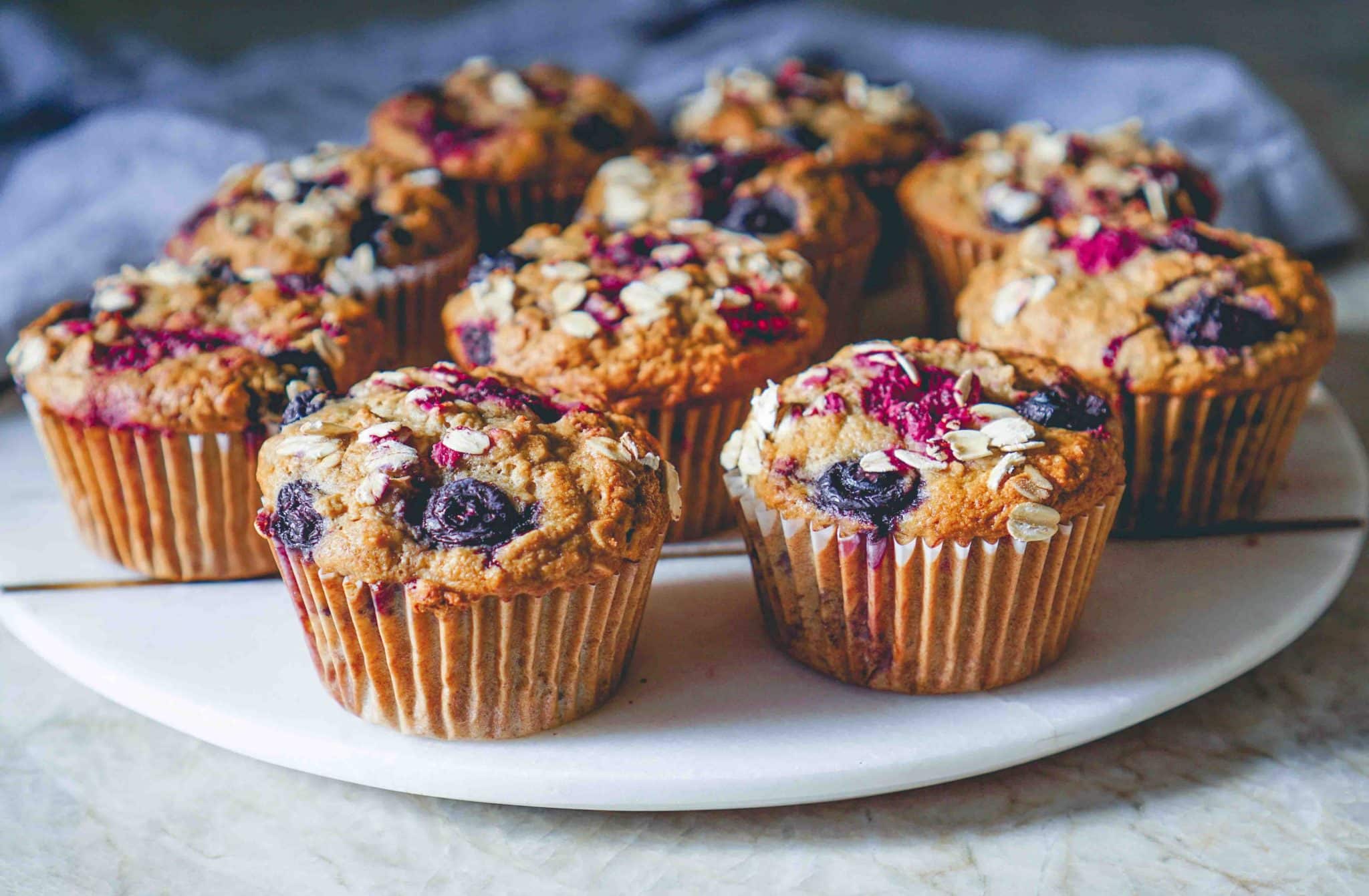 Vegan Gluten-free Oatmeal Banana Muffins with Mixed Berries on white plate.