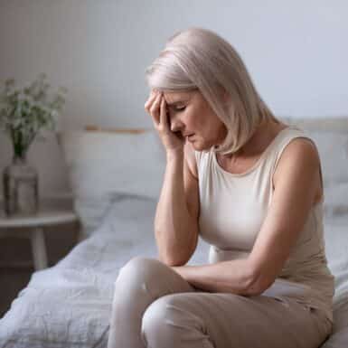 woman-holding-head-experiencing-magnesium-deficiency-headache