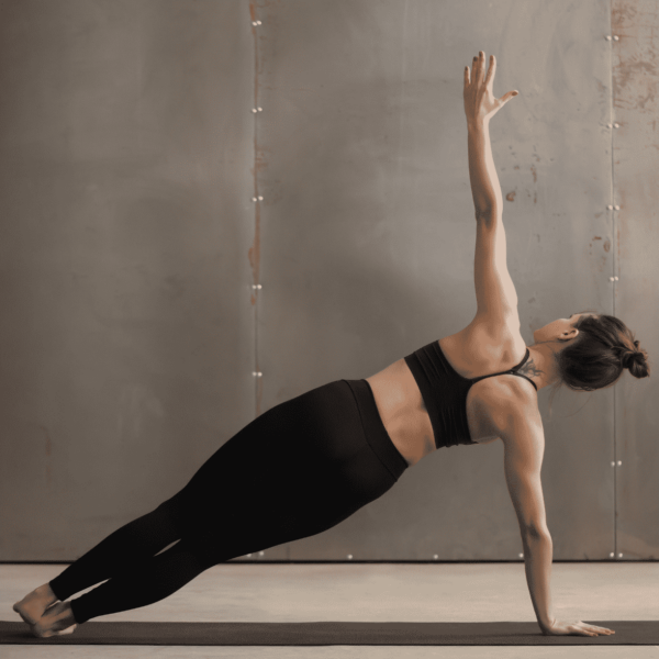 woman in black doing a side plank