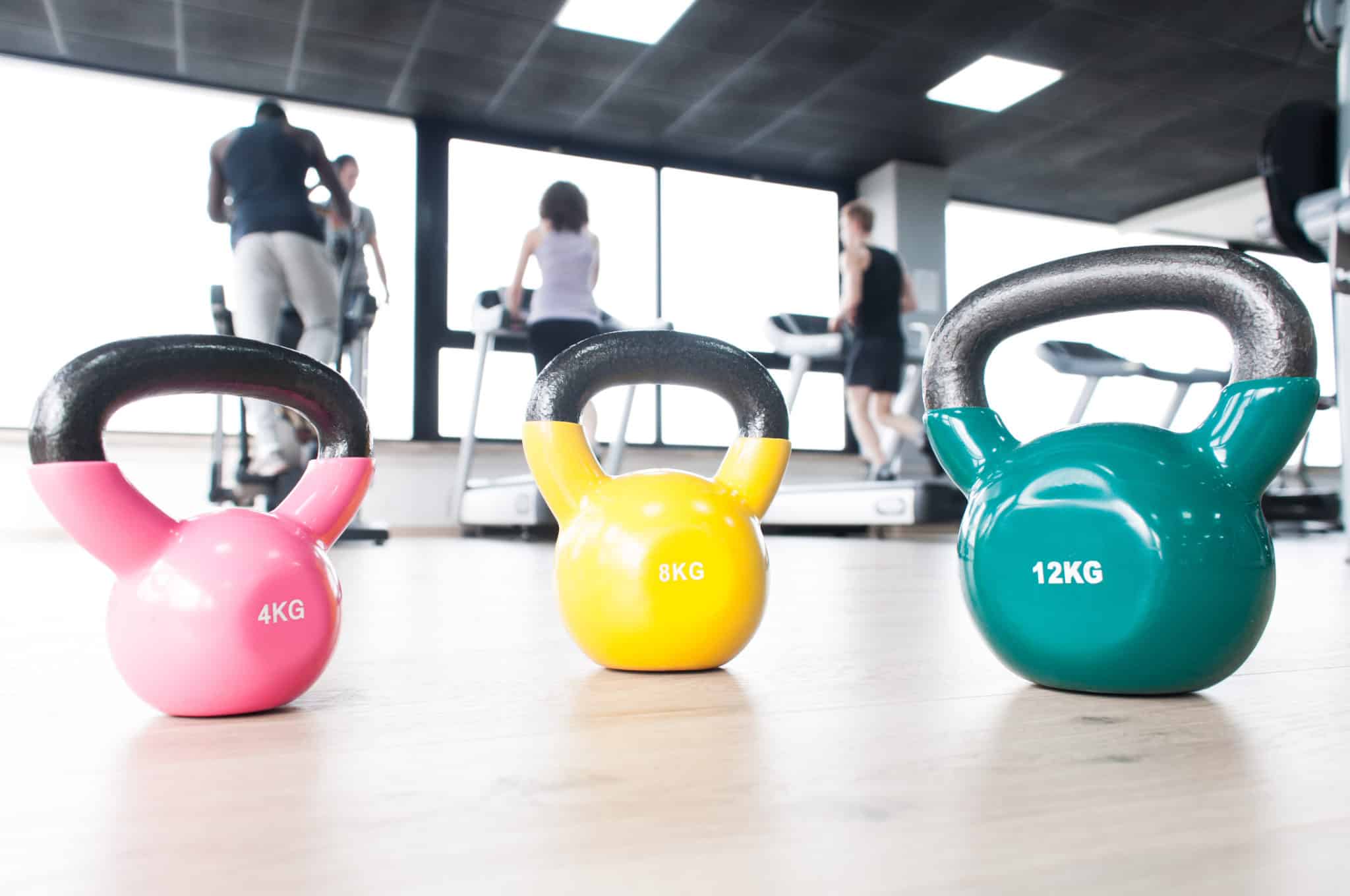 Different size and color kettlebells in a gym