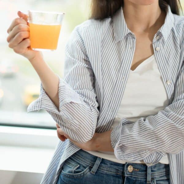 woman drinking apple cider vinegar in the morning