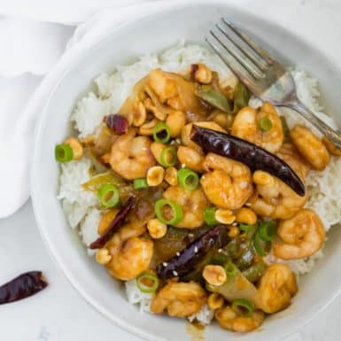Healthy Kung Pao Shrimp a bowl with dried red chiles