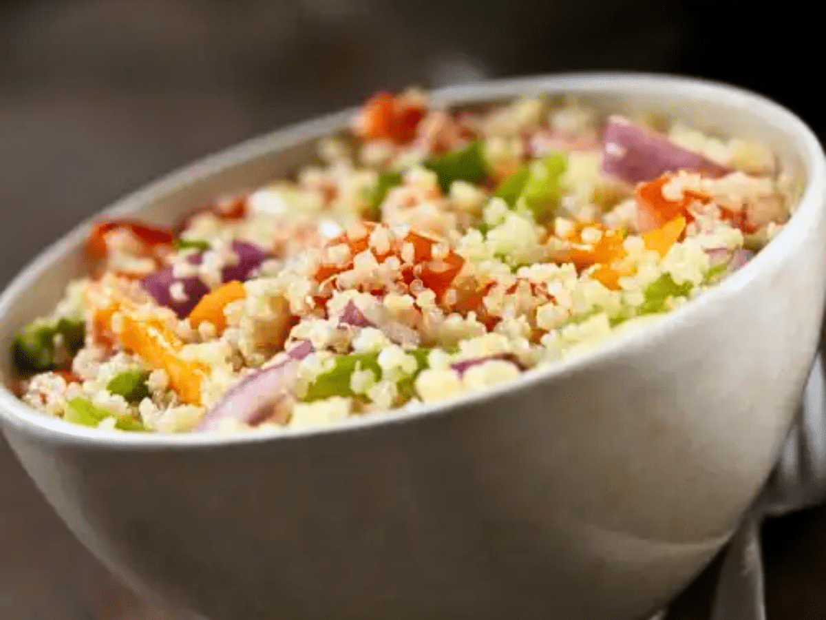 A colorful southwestern quinoa salad with tomatoes, onions and peppers.