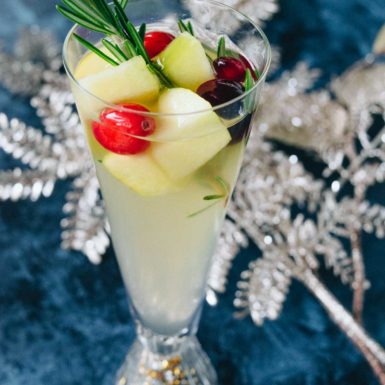 This delicious Christmas Sangria is so easy to make and tastes incredible! Infused with rosemary, apple cider, and fruit this healthier holiday beverage screams holiday fun!