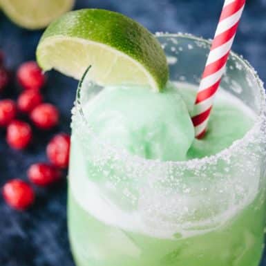 This festive and frothy Grinch Punch cocktail will jazz up your next holiday party with this lower cocktail everyone will love!