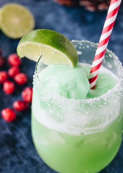 This festive and frothy Grinch Punch cocktail will jazz up your next holiday party with this lower cocktail everyone will love!