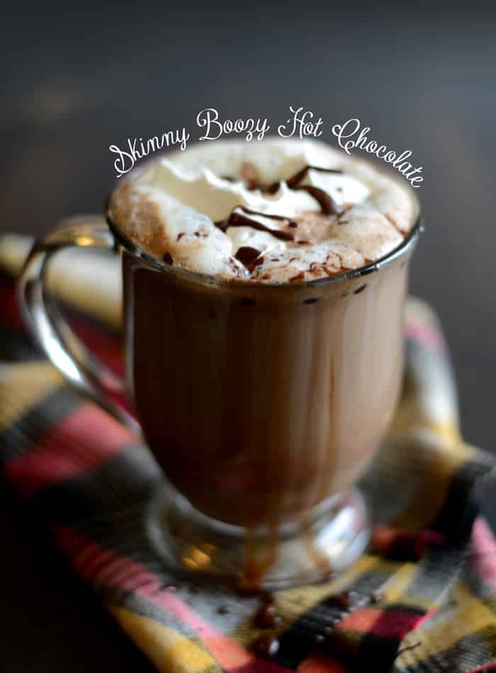 A glass of skinny boozy hot chocolate with whip cream and chocolate drizzle