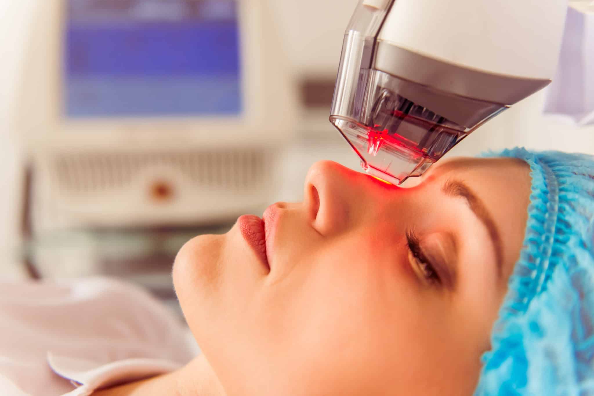 Photo of a woman getting laser therapy to promote collagen production.