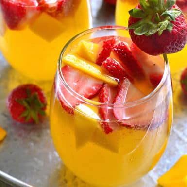 Check out this delicious summer cocktail recipe for Strawberry Mango Sangria! The perfect patio drink for warm summer nights!