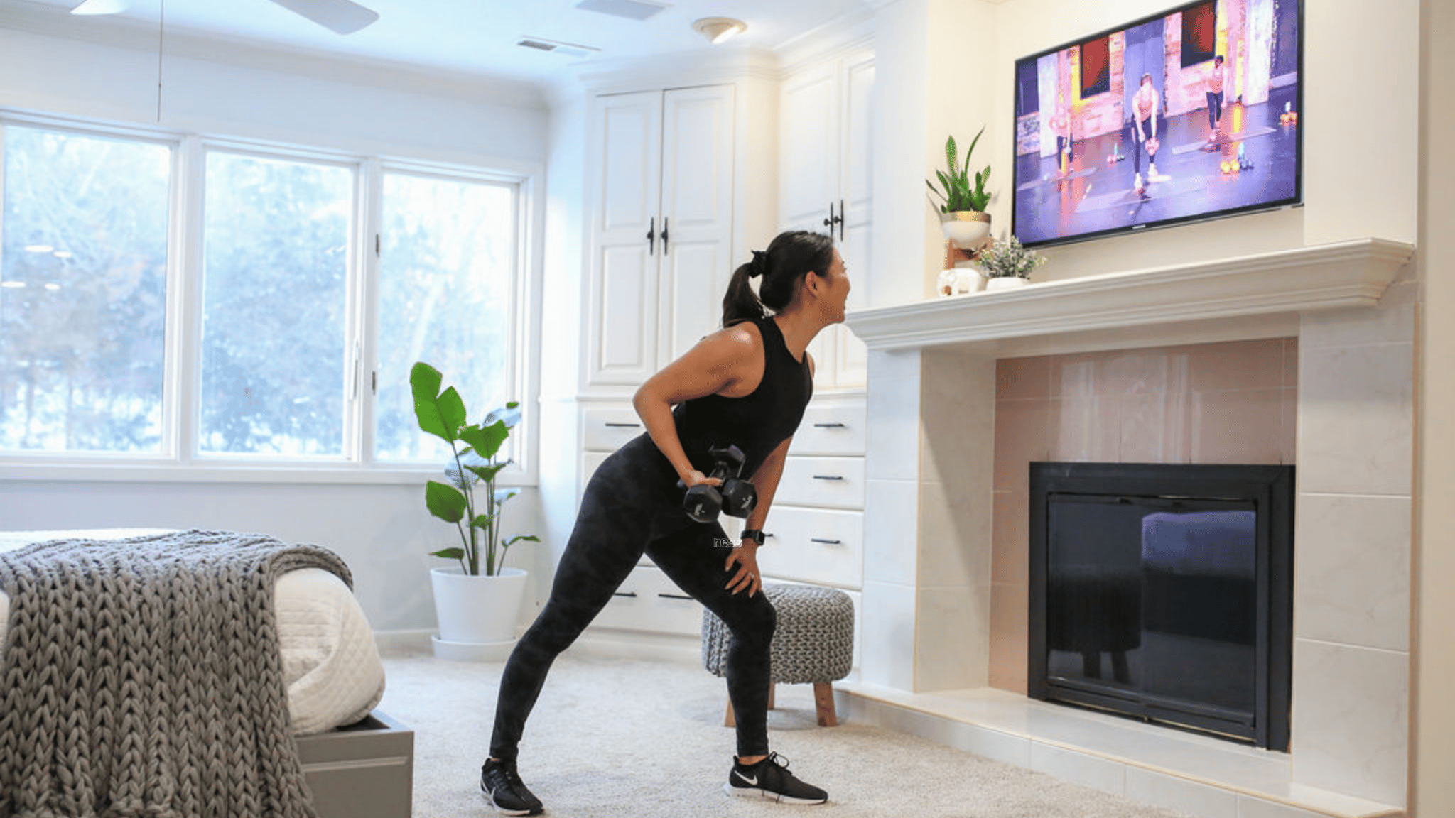 woman working out with her tv