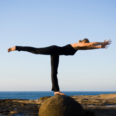 woman holding yoga pose outside