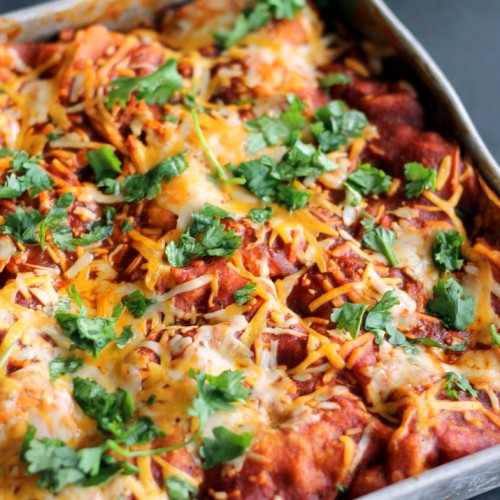Pan of BBQ Chicken & Sweet Potato Enchilada Casserole with cheese and cilantro on top