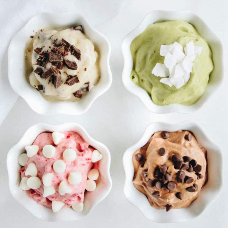 Four small bowls of banana "nice" cream in different flavors