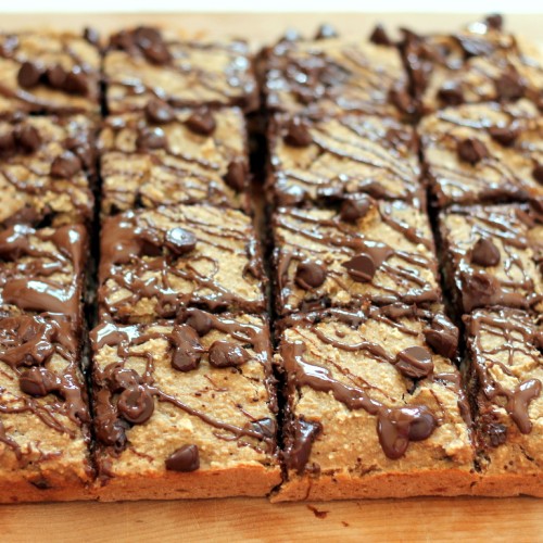 Chocolate chip oat banana bread bars cut up on wooden board