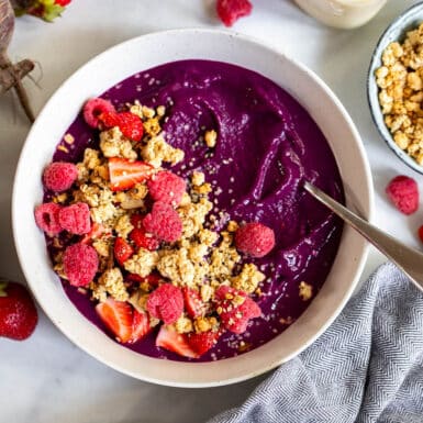 berry protein smoothie bowl prepared with toppings
