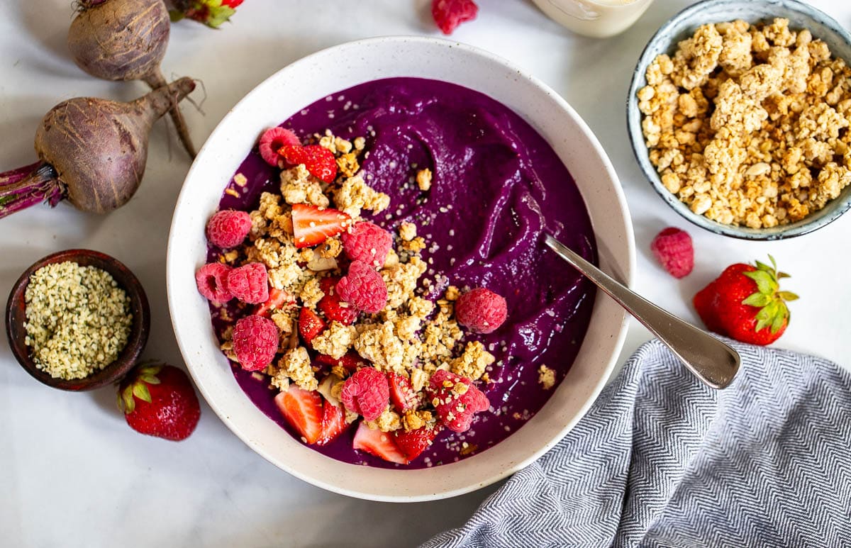 Berry protein smoothie bowl prepared with toppings