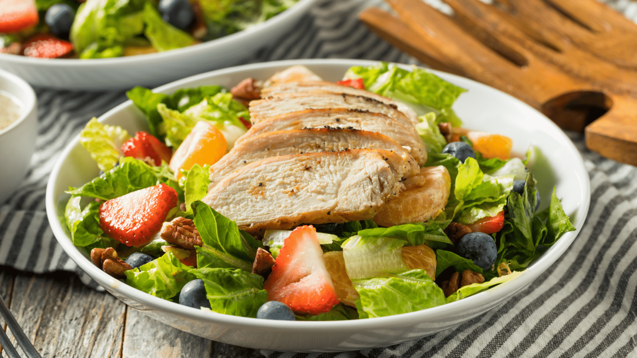 strawberry chicken salad in white bowl