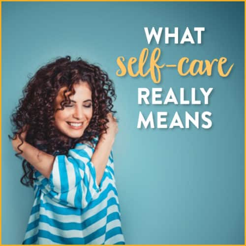 Woman with curly hair wrapping arms around herself with text: what self-care really means