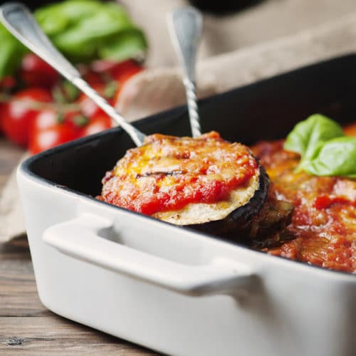 Healthy Eggplant Parmesan in white baking dish
