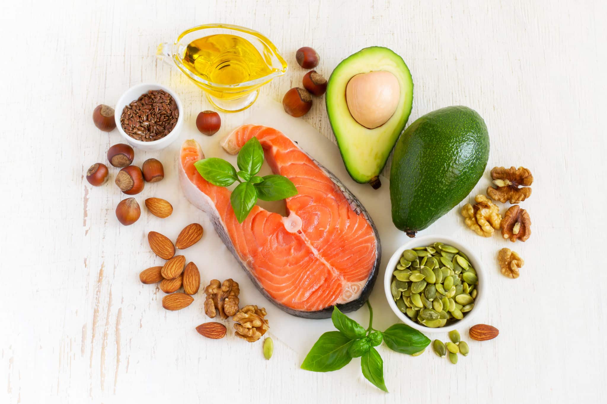 Table of healthy fats like salmon, avocado, nuts and seeds