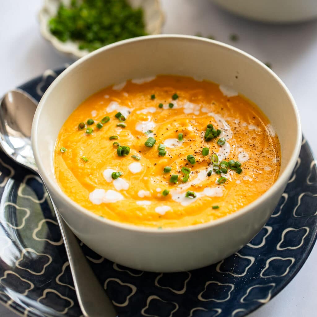 roasted sweet potato soup served in white bowl