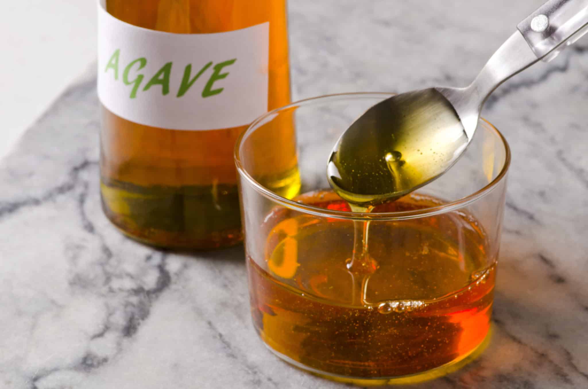 Agave syrup in glass with spoon