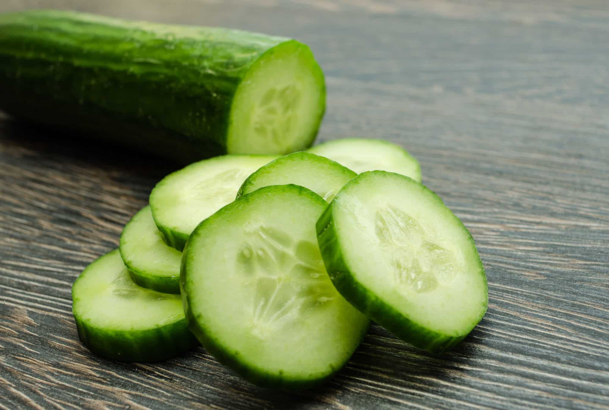 Sliced cucumber on wooden table