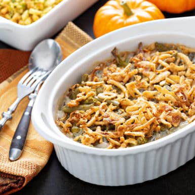 Green bean casserole on holiday table in white corning dish