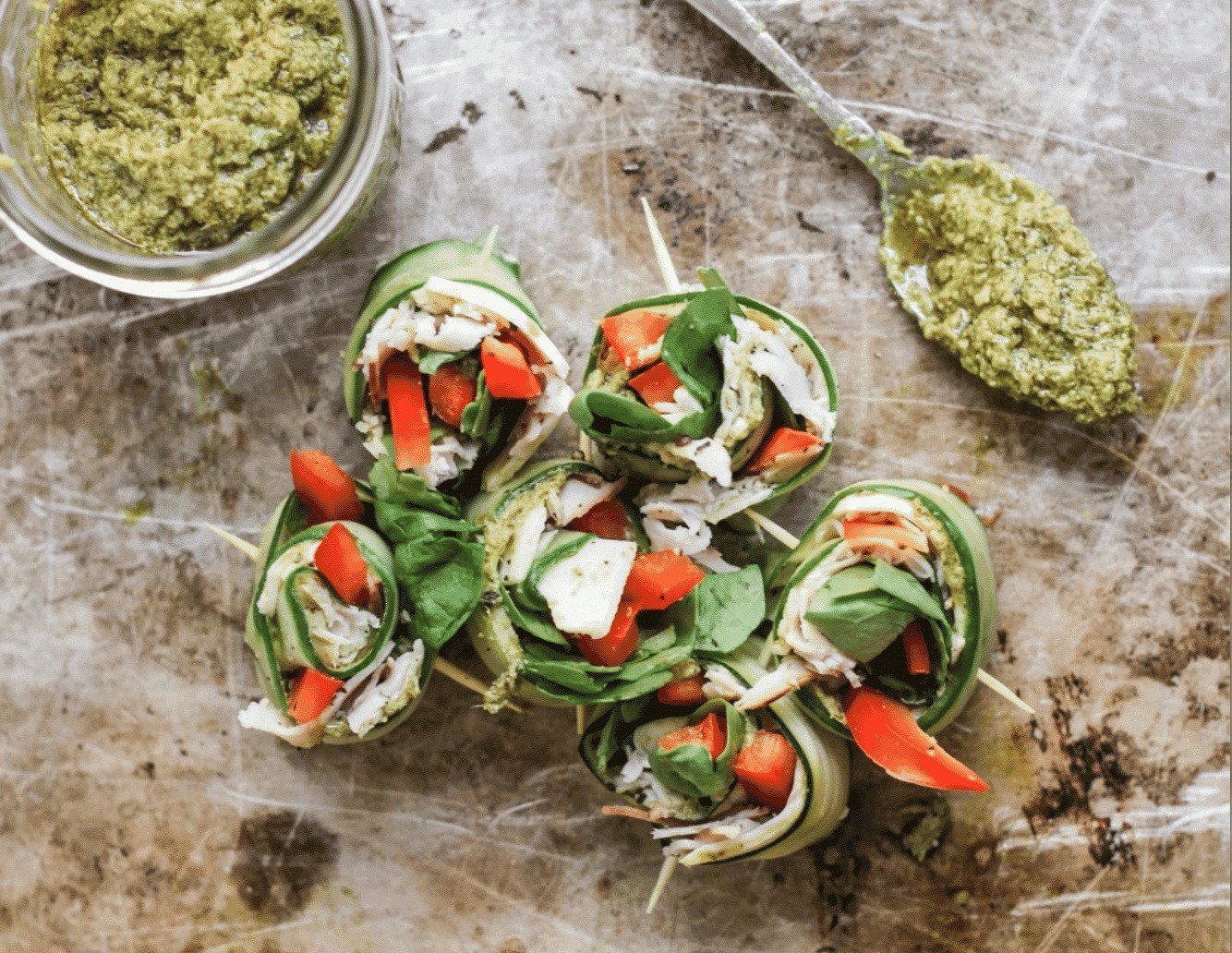 cucumbers rolled with bowl of pesto