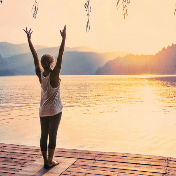 woman doing a sun salutation outside